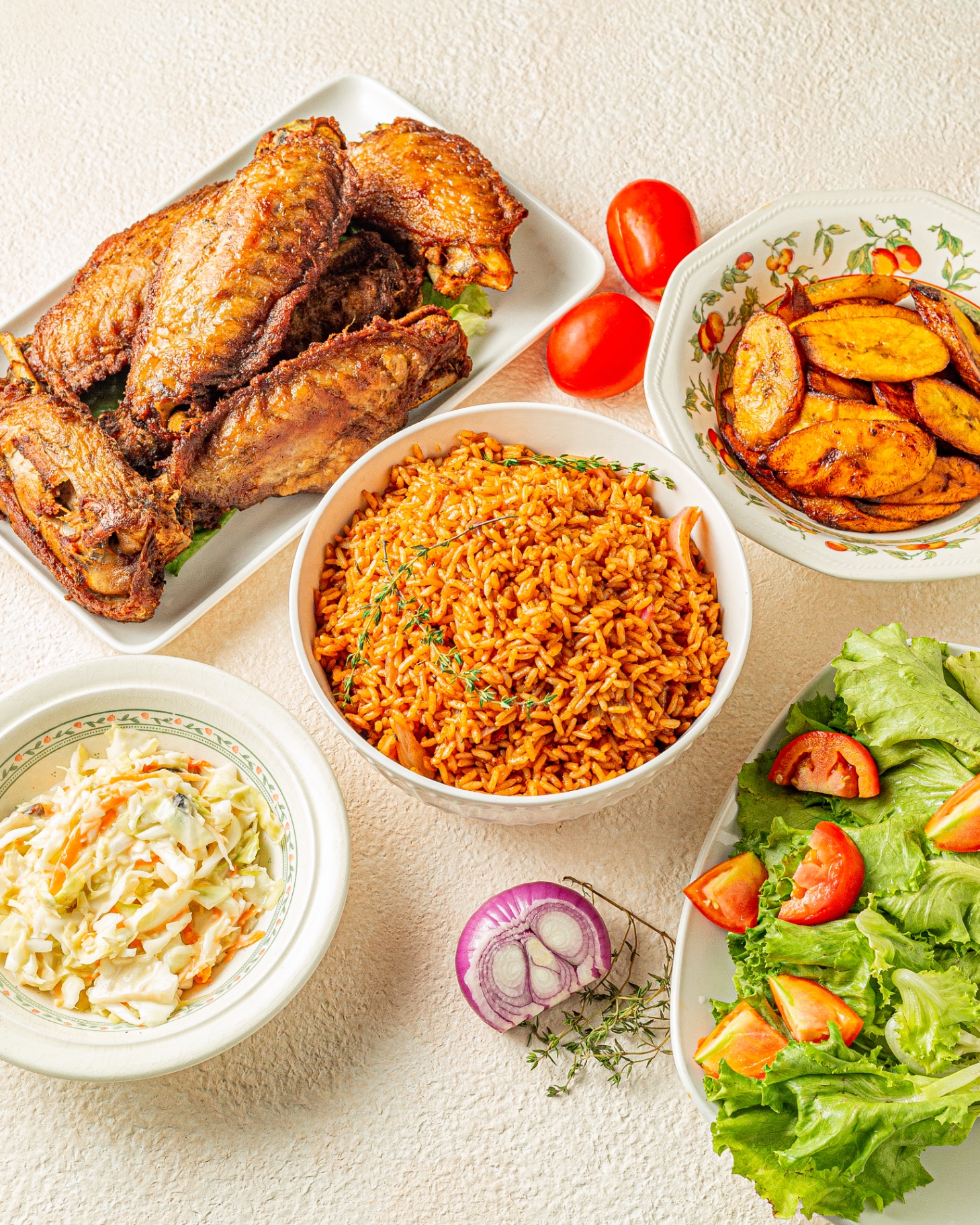 Jollof rice with chicken, plantains and salad